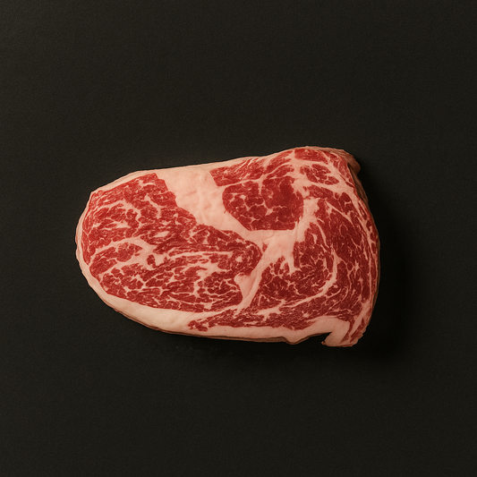 Raw Wagyu cuberoll MB9+, boneless with intense marbling and trimmed fat cap, placed on butcher tray
