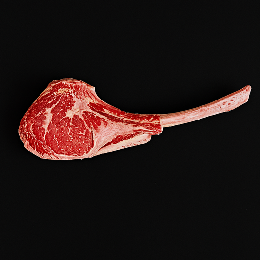 Raw Wagyu tomahawk steak MB6/7, thick-cut with long bone and intense marbling, displayed on butcher board