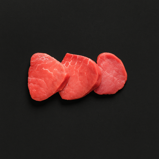 Raw gluten-free beef tenderloin, boneless with lean texture and trimmed edges, placed on butcher tray with certified gluten-free label