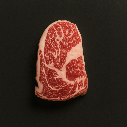 Raw grass-fed beef cube roll, boneless with lean texture and light marbling, placed on butcher tray